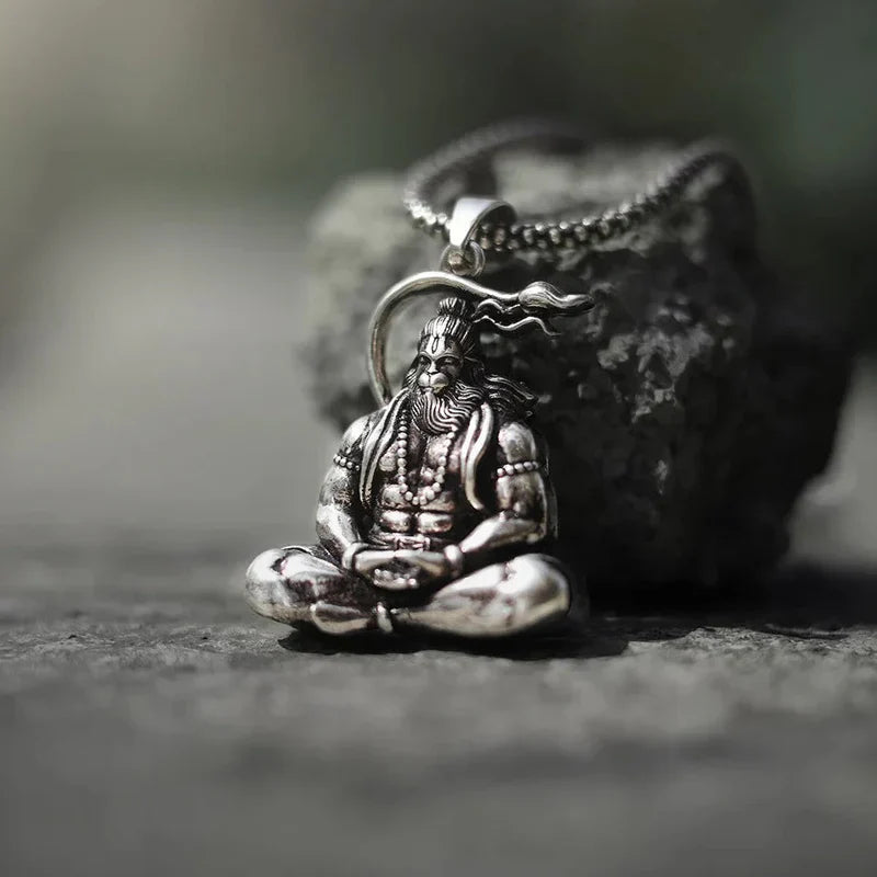 Detailed spiritual pendant featuring a seated figure with intricate designs and a chain
