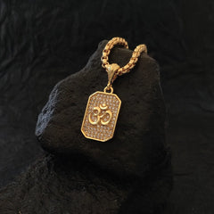 Devam Om diamond pendant necklace in gold with intricate detailing on a textured surface
